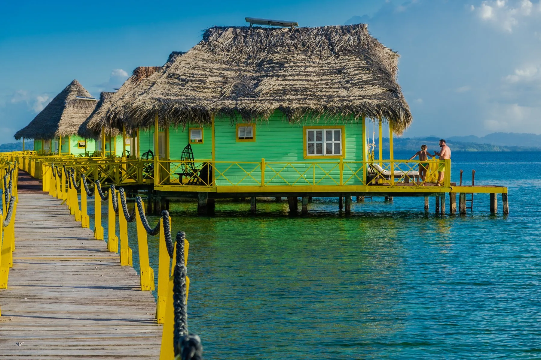 Guests on the deck of an overwater bungalow at the boutique hotel in Bocas del Toro, Panama
